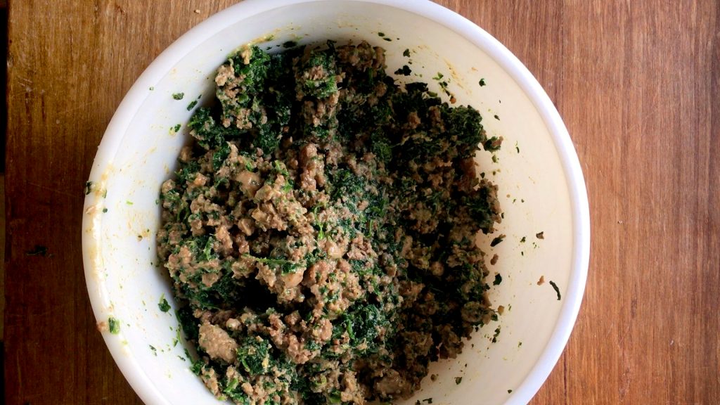 Cooked meat with spinach in a bowl