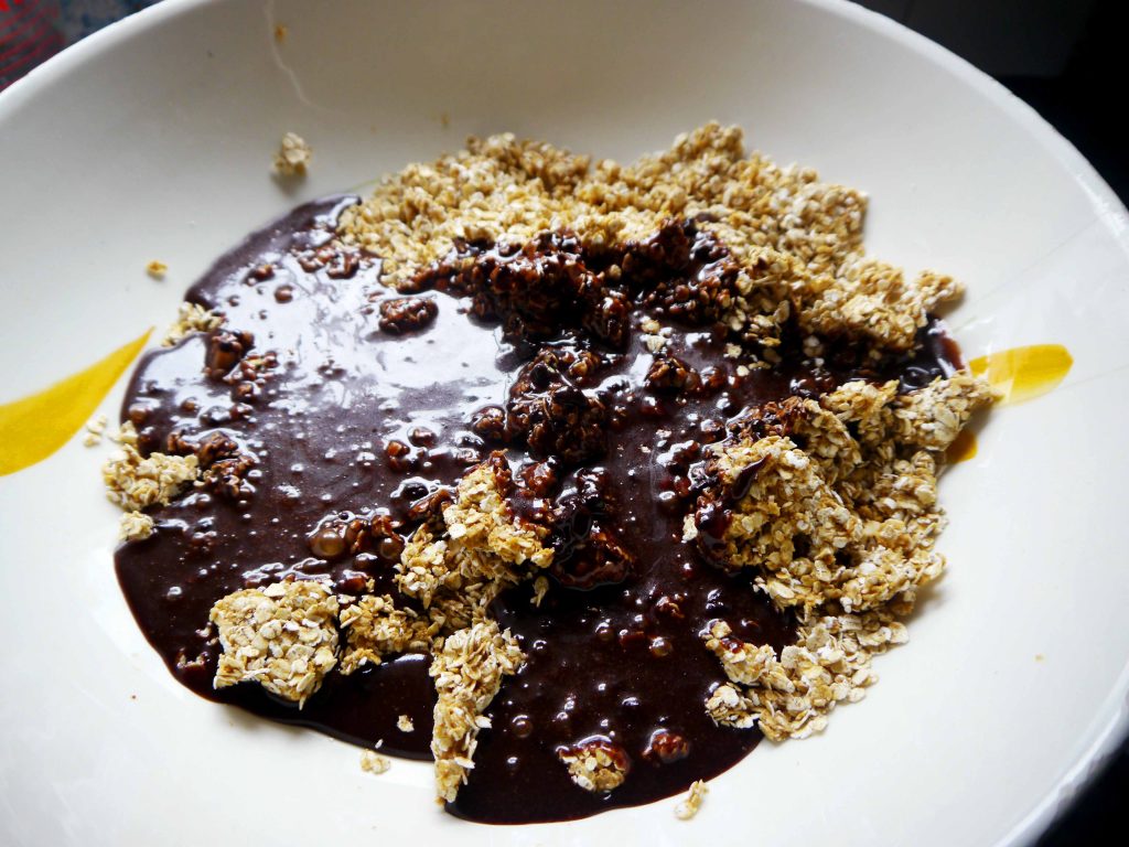 melted chocolate on top of oats in a bowl