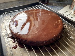 Chocolate icing poured over the cake.
